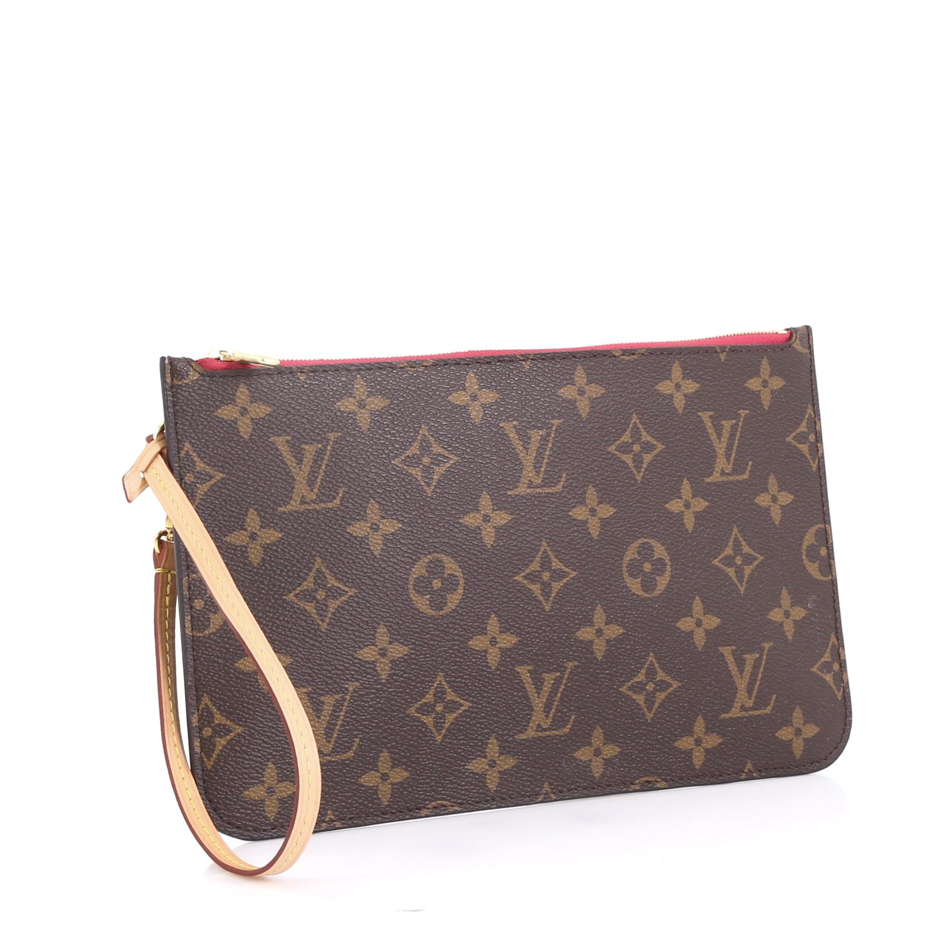 This Louis Vuitton Neverfull Pochette Monogram Canvas Large, crafted from brown monogram coated canvas, features gold-tone hardware. Its zip closure opens to a pink fabric interior with slip pocket. Authenticity code reads: CA1168. 

Condition: