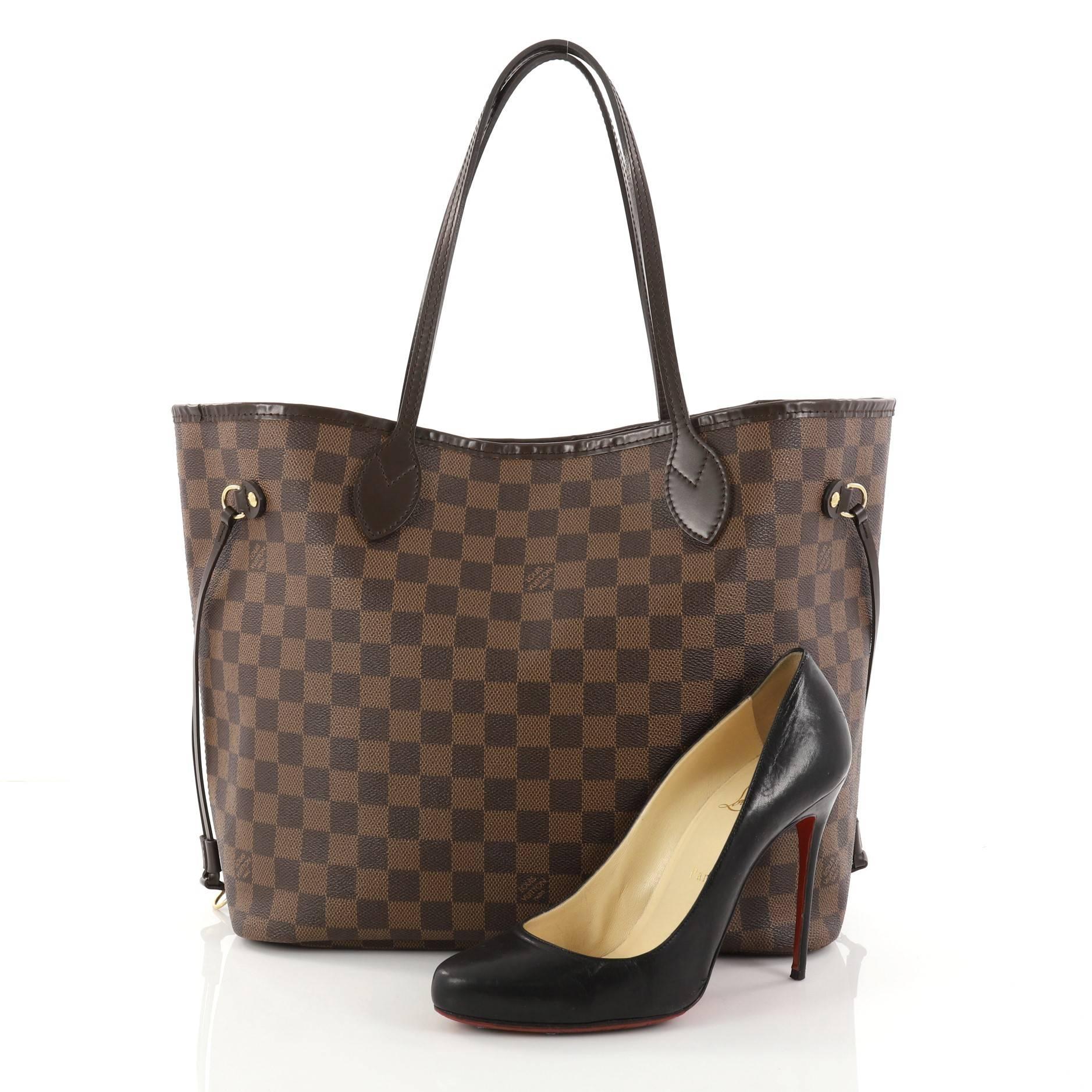 This authentic Louis Vuitton Neverfull Tote Damier MM is a popular and practical tote beloved by many. Constructed with Louis Vuitton's signature damier ebene coated canvas, this tote is spacious and structured without being bulky. The side laces