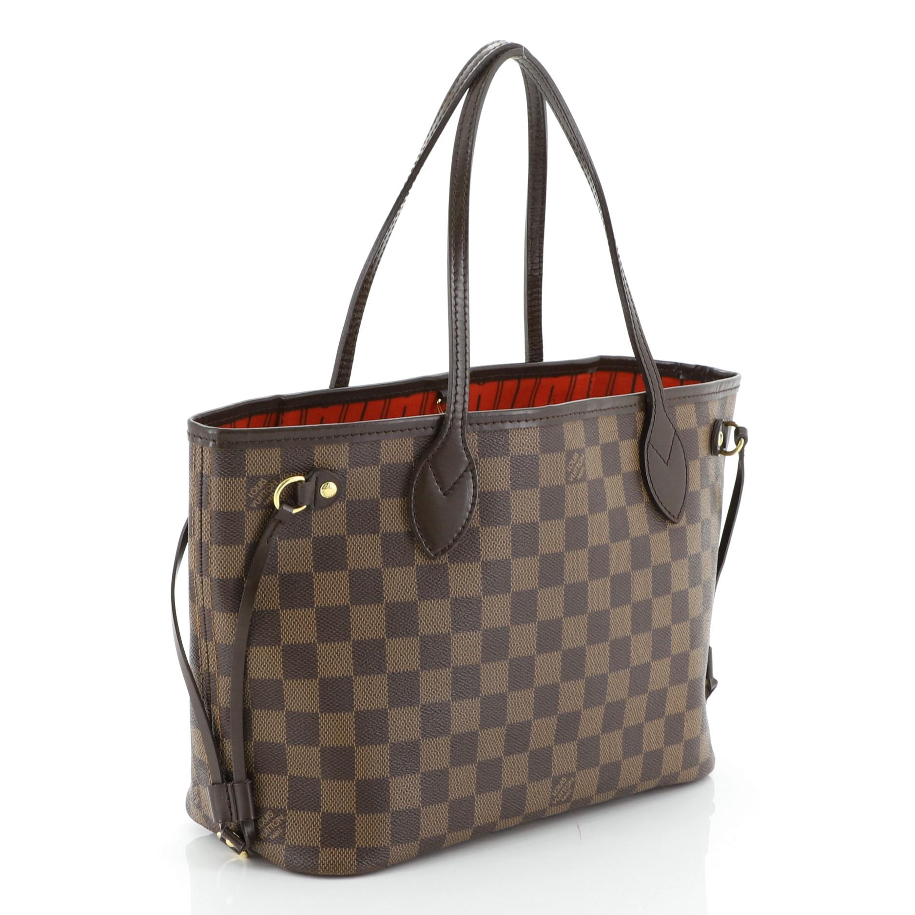 This Louis Vuitton Neverfull Tote Damier PM, crafted in damier ebene coated canvas, features dual slim handles, side laces, and gold-tone hardware. Its wide open top showcases a red fabric interior with side zip pocket. Authenticity code reads: