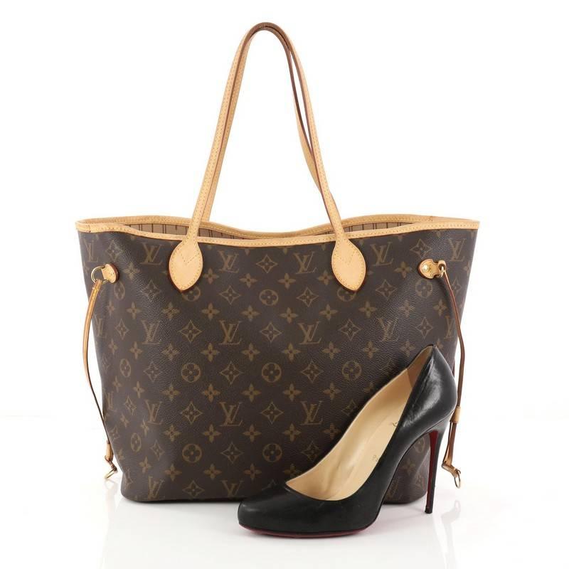 This authentic Louis Vuitton Neverfull Tote Monogram Canvas MM is a popular and practical oversized tote beloved by many. Constructed with Louis Vuitton's signature brown monogram coated canvas, this tote features dual slim vachetta leather handles,