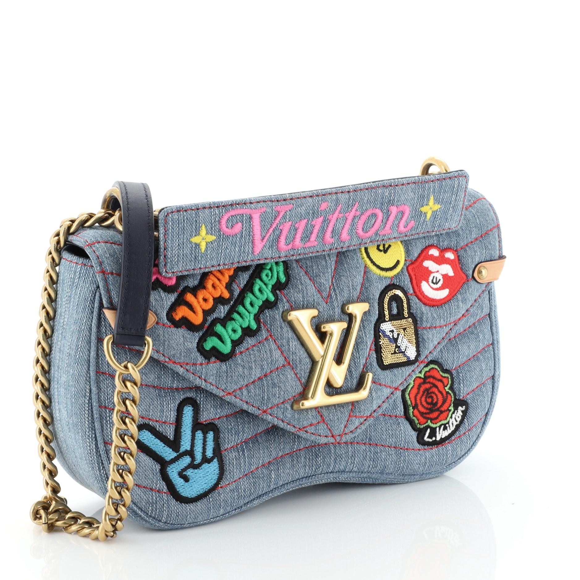 This Louis Vuitton New Wave Chain Bag Limited Edition Patches Quilted Denim MM crafted from blue quilted deniim, features a sliding chain-link shoulder strap with leather pad, detachable handle signed “Louis Vuitton,” colourful textile patches and