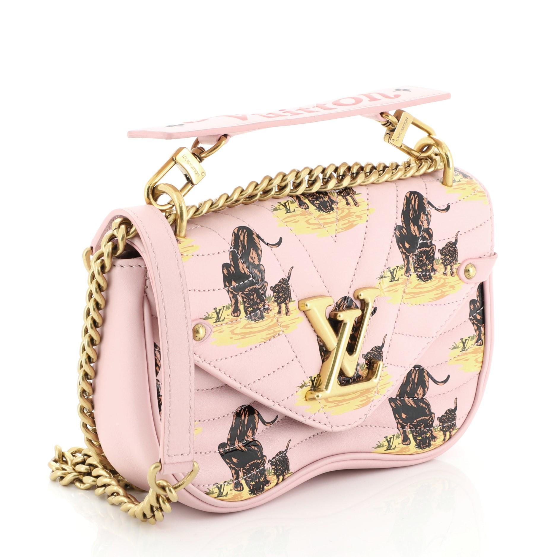 This Louis Vuitton New Wave Chain Bag Limited Edition Printed Quilted Leather PM, crafted from pink printed leather, features sliding chain-link shoulder strap with leather pad, detachable handle signed “Louis Vuitton,” and gold-tone hardware. It