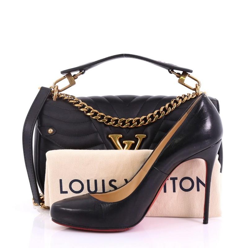 This Louis Vuitton New Wave Chain Bag Quilted Leather MM, crafted from black quilted leather, features a sliding chain-link shoulder strap with leather pad, detachable handle signed “Louis Vuitton,” and aged gold-tone hardware. It opens to a black