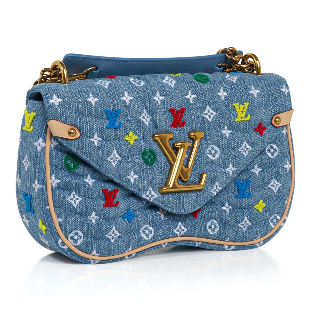 Limited edition Louis Vuitton New Wave Chain Bag MM.  
Introduced in Spring-Summer 2019 season.
The bag comes in blue quilted LV denim with multicolored embroidered and tufted flowers and LV's. 
A versatile bag - can be carried as a top handle bag,