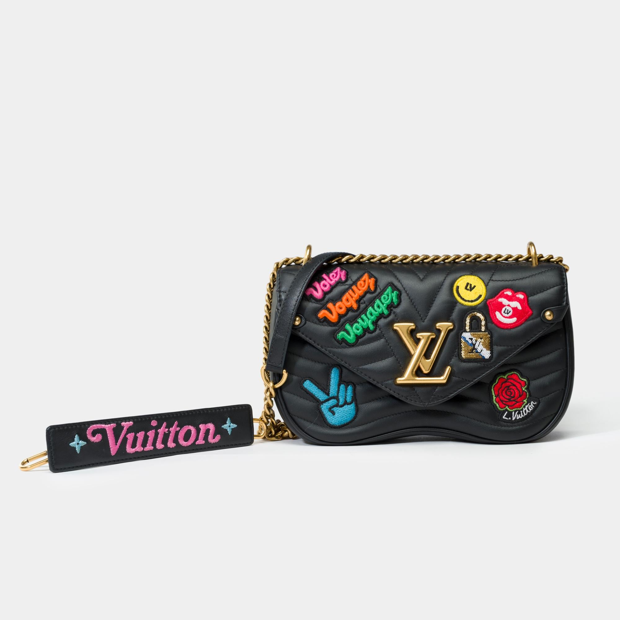 Crafted​ ​from​ ​soft,​ ​quilted​ ​calfskin​ ​leather,​ ​this​ ​New​ ​Wave​ ​chain​ ​bag​ ​comes​ ​in​ ​black.​ ​The​ ​iconic​ ​LV​ ​lock​ ​and​ ​metal​ ​hardware​ ​feature​ ​an​ ​antique​ ​gold​ ​finish,​ ​giving​ ​the​ ​model​ ​a​ ​retro​ ​look.​