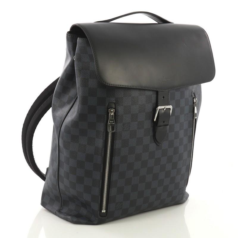 This Louis Vuitton Newport Backpack Damier Cobalt, crafted from damier cobalt coated canvas, features padded back straps, leather top handle, front zip pockets, and silver-tone hardware. Its flap top belt closure opens to a navy microfiber interior