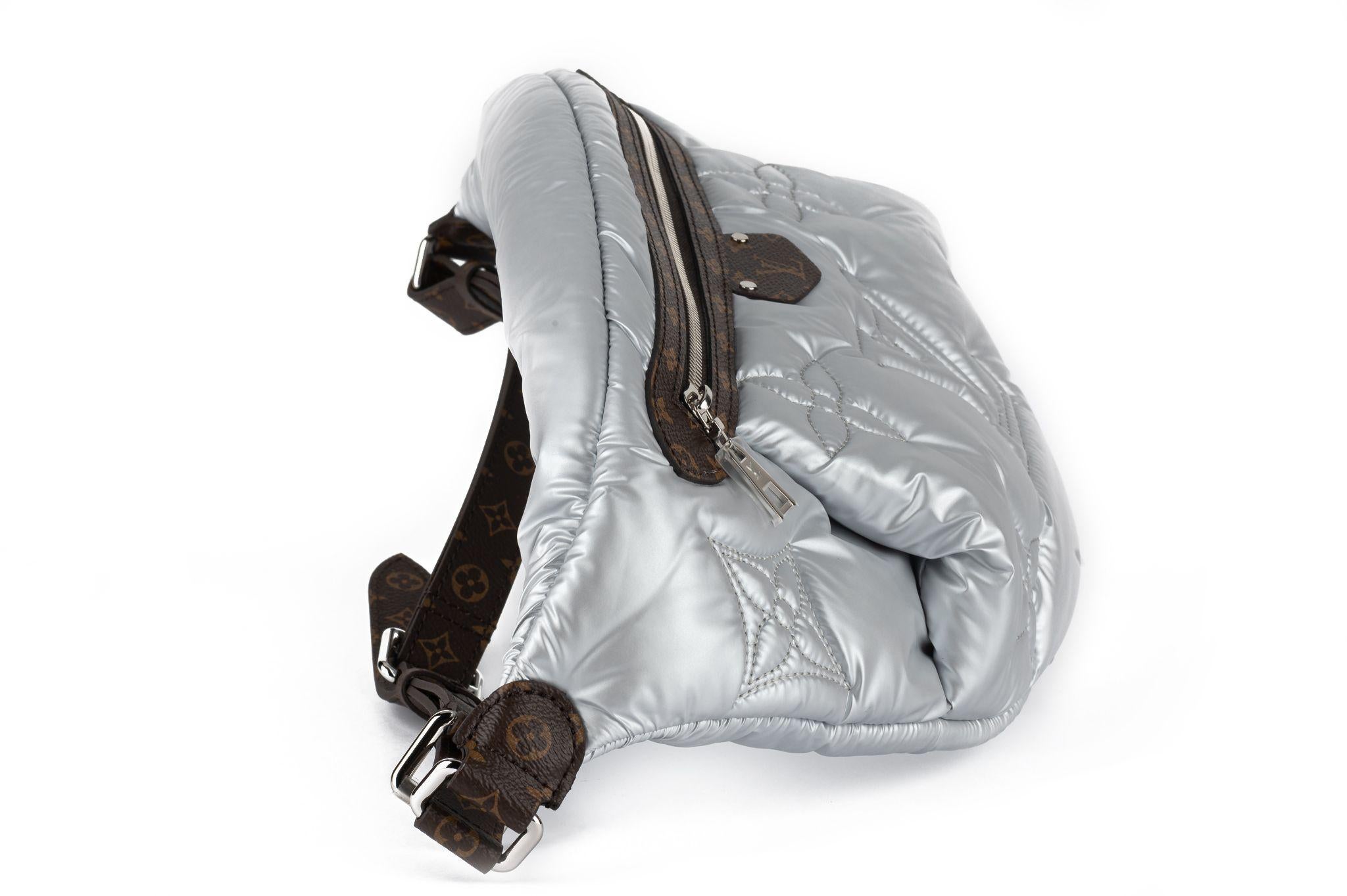 Louis Vuitton new collectible pillow bumbag in silver recycled eco nylon. Brown monogram details. Strap is removable and adjustable. Strap drop 9.8-19-8. Comes with original dustcover and box.
