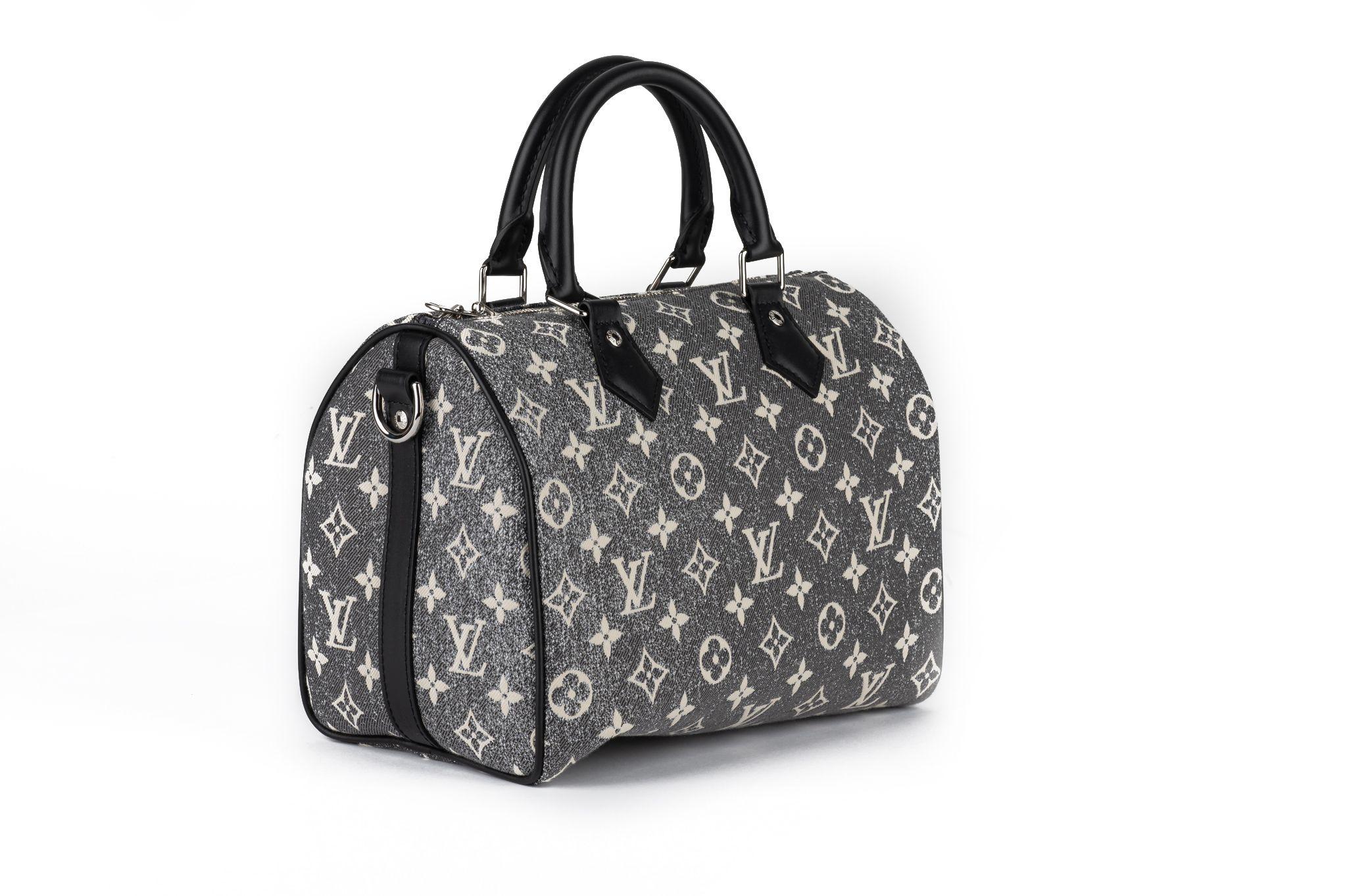 Louis Vuitton new speedy 25 in grey denim monogram toile and black cowhide trim. Handle drops 3”, detachable and adjustable shoulder strap 20.5”. Comes with original dust cover and box.