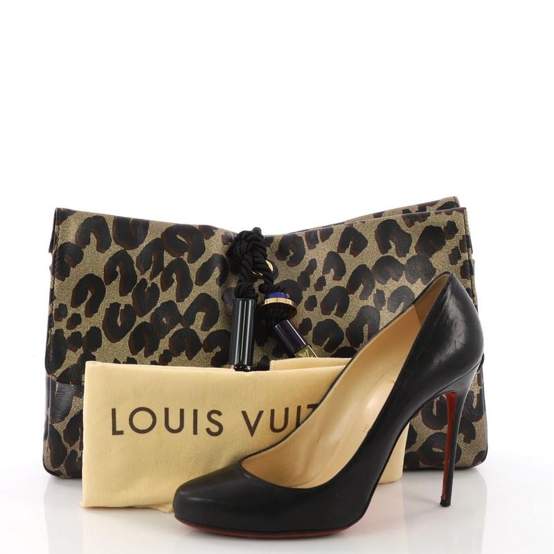 This Louis Vuitton Nocturne Clutch Limited Edition African Queen, crafted in cheetah print leather, features resin and metal beads and embellishments, black twisted drawstring at the top, LV engraved nameplate and gold-tone hardware. Its magnetic