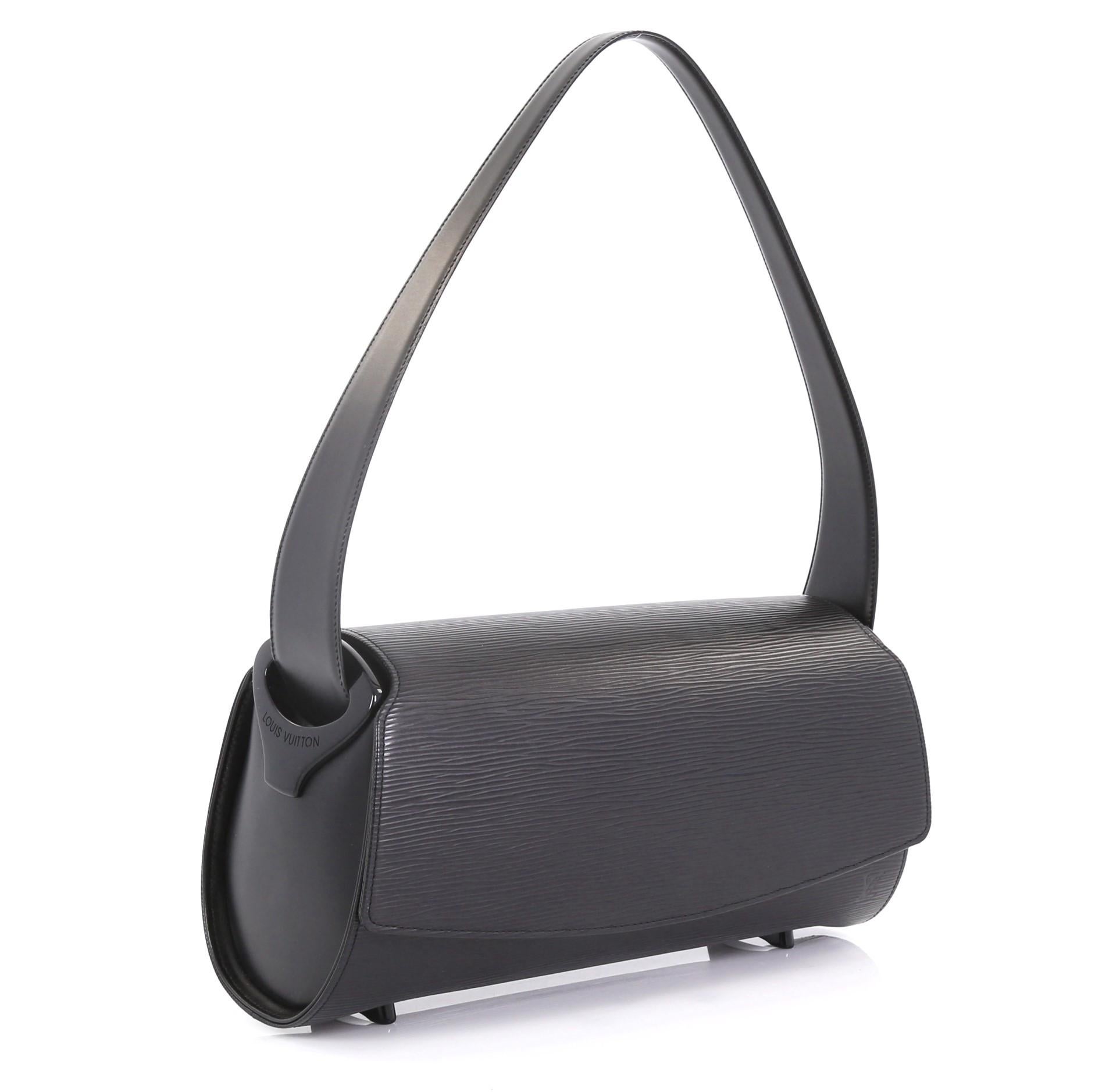 This Louis Vuitton Nocturne Handbag Epi Leather GM, crafted from black epi leather, features a single looped leather handle with resin accents, protective feet, frontal flap, subtle LV logo, and gold-tone hardware. Its magnetic snap closure opens to