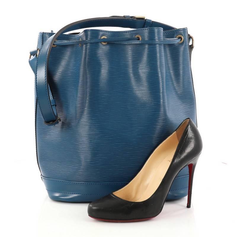 This authentic Louis Vuitton Noe Handbag Epi Leather Large is a chic and iconic bucket bag made for the modern fashionista. Crafted from blue epi leather, this bucket bag features adjustable shoulder straps, subtle LV logo, leather drawstring
