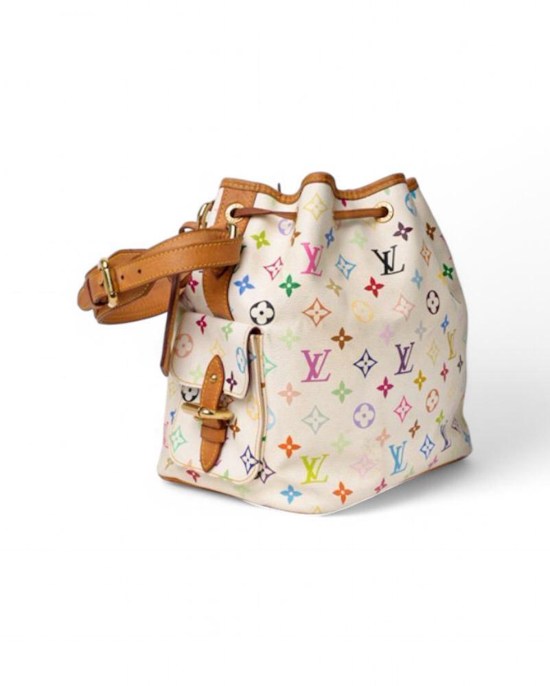 Louis Vuitton signature bag, limited edition in collaboration with Takashi Murakami. Noah model in size MM, made of multicolor white canvas with cowhide inserts and gold hardware. Featuring a drawstring top closure, internally lined in burgundy