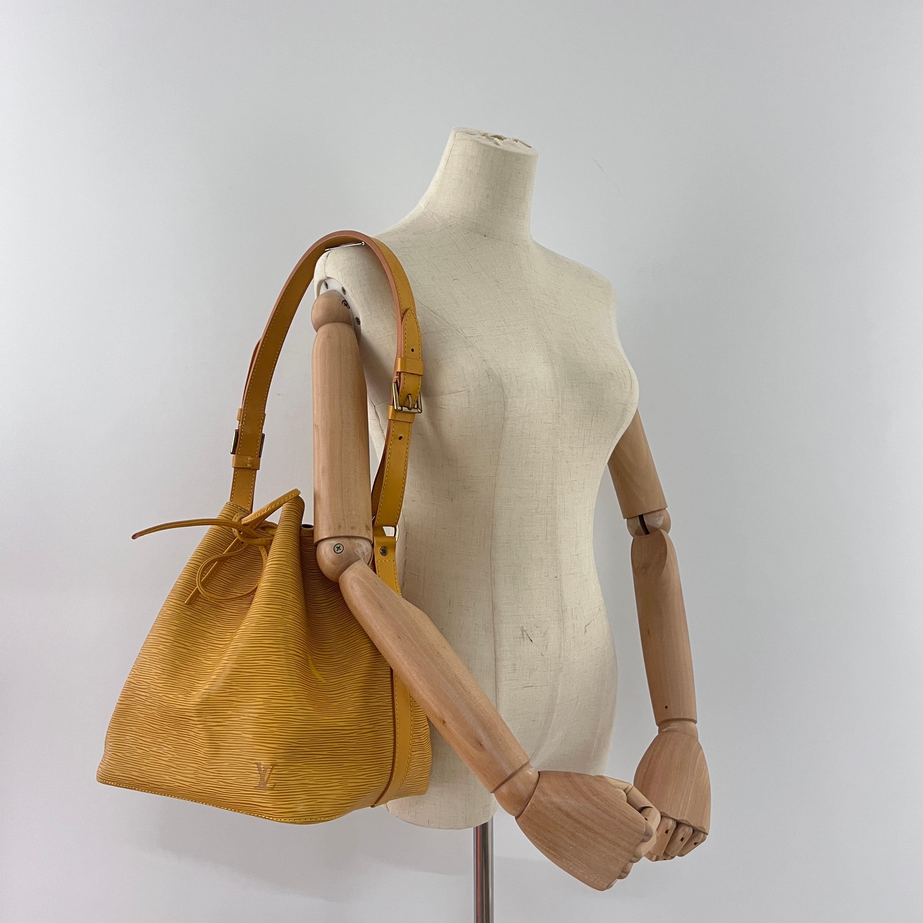 LOUIS VUITTON Noé Petit en cuir jaune et métal doré. Le sac est muni d'un cordon de serrage. L'intérieur se compose d'un compartiment principal. Peut être porté à la main. Code de date AR0988, année de production 1998, France. Le sac est en très bon