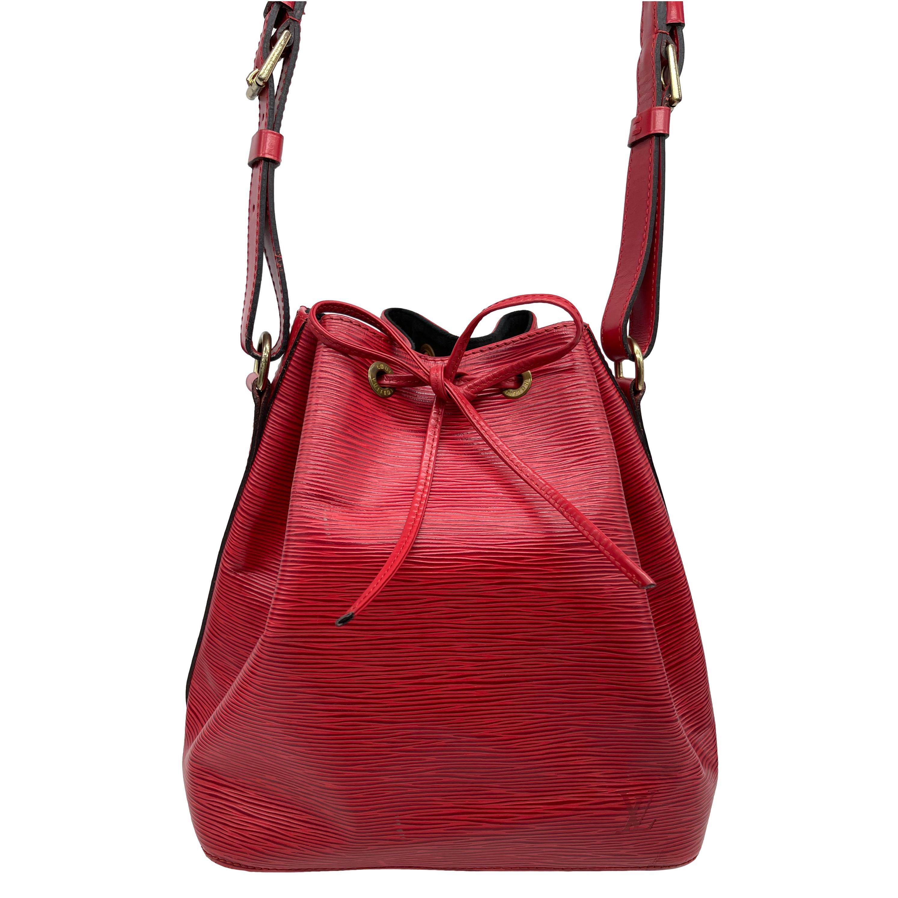 Vintage Louis Vuitton “Noe” PM Bucket Bag in Red EPI Leather, circa 1993. Made in France, the Noe was originally designed by Louis Vuitton’s grandson in 1932 as a bag to carry champagne, specifically four bottles upright and one inverted in the