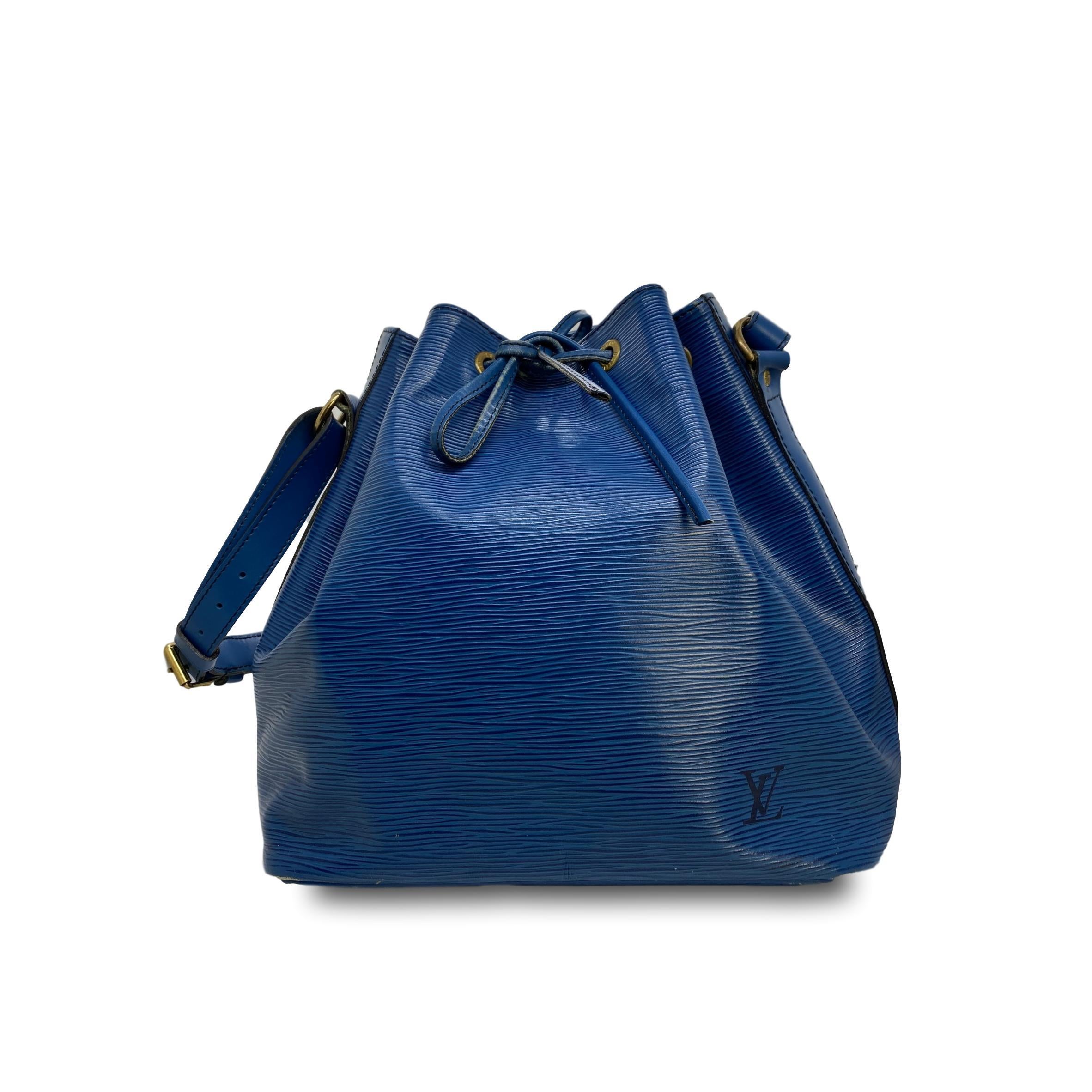 Vintage Louis Vuitton “Noe” Toledo Blue EPI Leather Bucket Bag, February 1995. Made in France, the Noe was originally designed by Louis Vuitton’s grandson in 1932 as a bag to carry champagne, specifically four bottles upright and one inverted in the