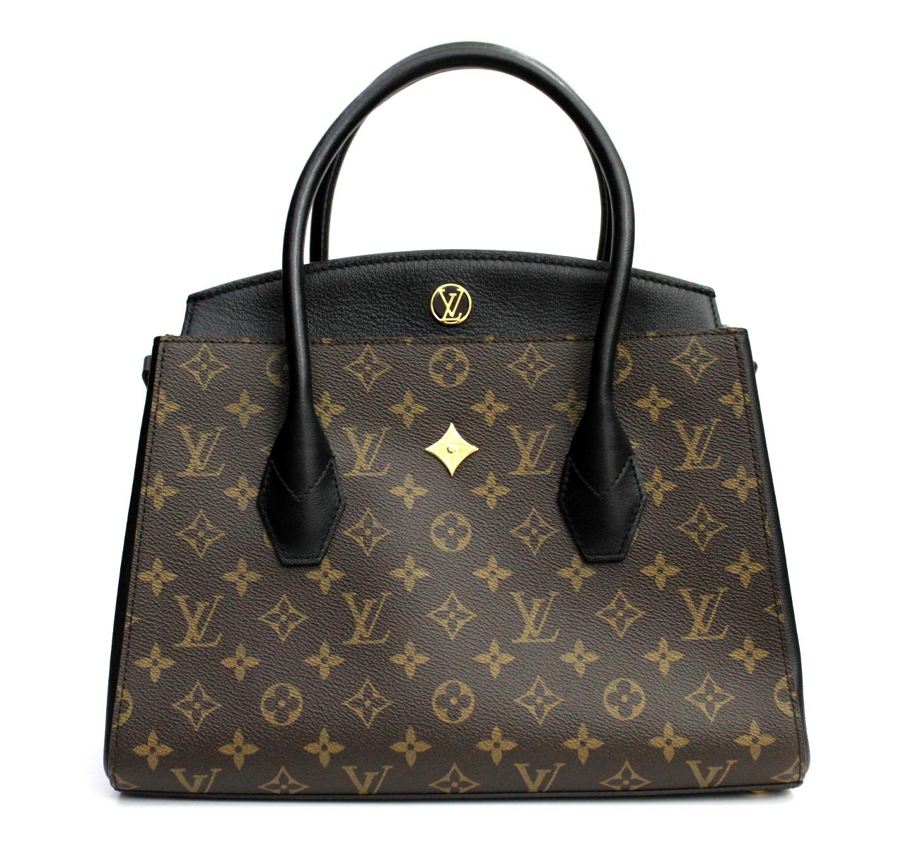 LOUIS VUITTON Noir Monogram Canvas Florine Bag.  It features the Monogram canvas with black calf leather details and golden metallic hardware. It has rolled Toron handles and a detachable shoulder strap. It has two compartments - one with a flap top