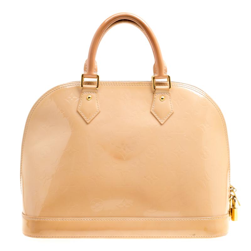 A classic from the house of Louis Vuitton, the shape of the Alma stands out. Louis Vuitton Alma was named after the Alma Bridge that connects Paris's fashionable neighborhood. The bag is made from signature Monogram Vernis that was introduced in