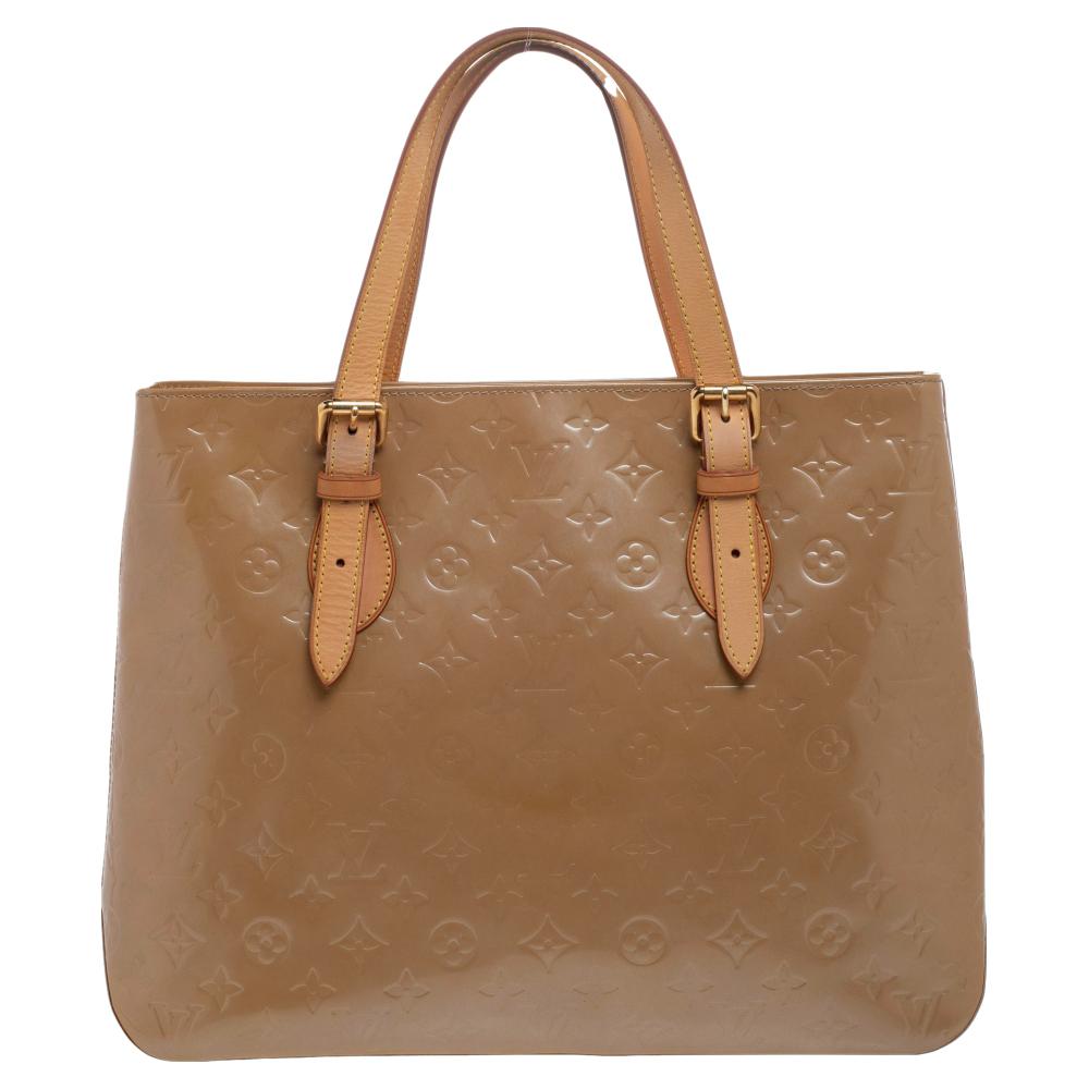 This Brentwood bag will be a reliable style companion! This Louis Vuitton creation has been beautifully crafted from signature Monogram Vernis and styled with top handles. The interior is lined with fabric and sized to hold all your essentials.

