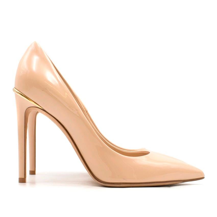 Louis Vuitton Nude Patent Leather First Lady Pumps

- Nude glossy patent leather
- Pointed toe
- Slip-on style
- Nude leather lining and sole
- High covered stiletto heel
- Gold-tone embossed Louis Vuitton plaque at heel

Condition: Never worn