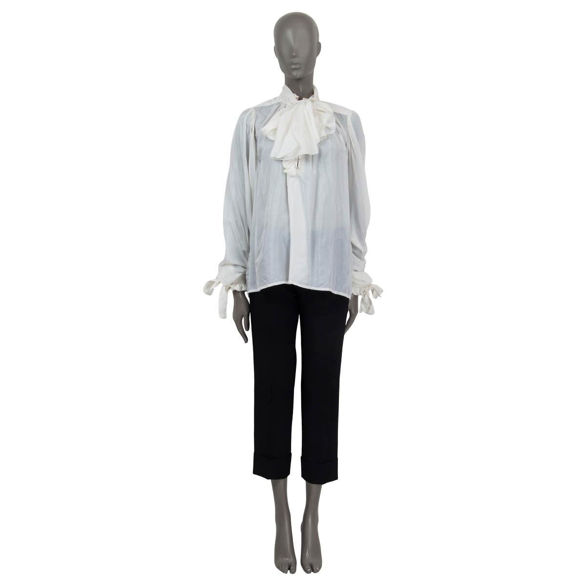 100% authentic Louis Vuitton semi sheer ruffled long sleeve blouse in off-white silk (100%). Features a pussy bow at the neck and ruffled, buttoned cuffs. Opens with hooks on the front. Unlined. Has been worn and is in excellent