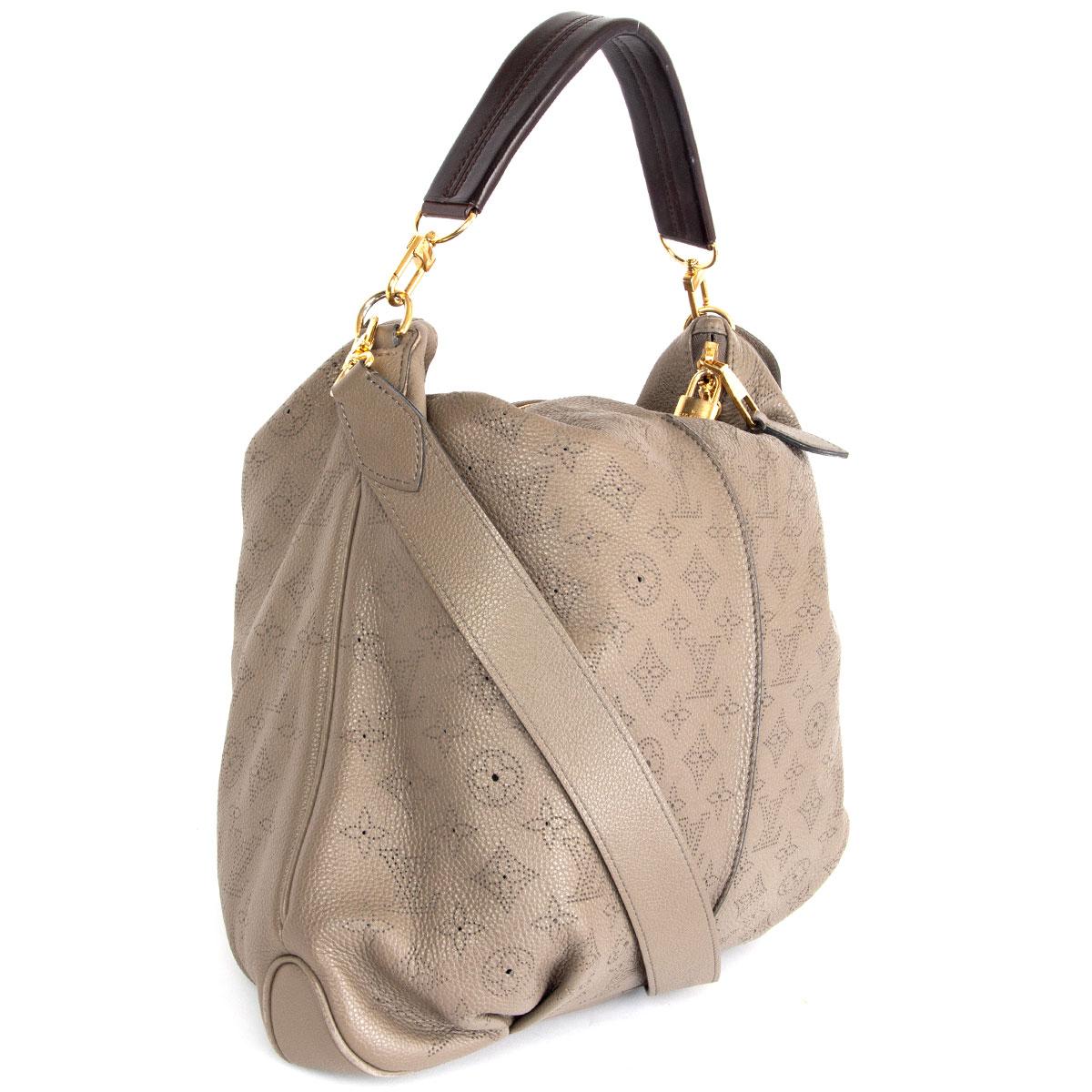 100% authentic Louis Vuitton Mahina Selene MM Bag in Monogram taupe Mahina calfskin featuring a espresso brown top handle. Opens with a double-zip on top and is lined in back microfibre with one zipper pocket against the back and two open pockets