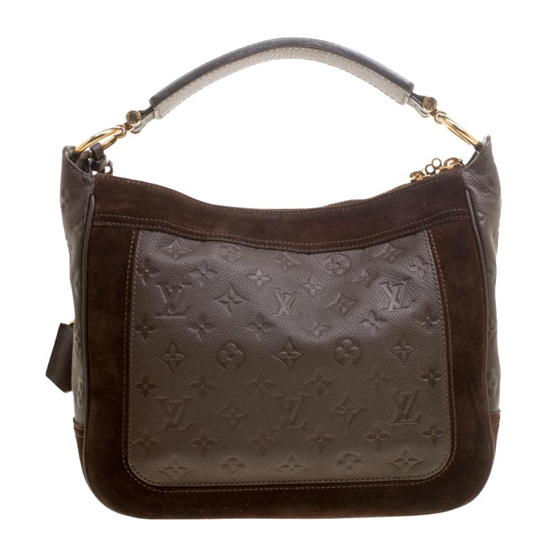 Flaunt this Louis Vuitton Audacieuse PM bag like a fashionista! Crafted from suede and monogram Empreinte leather, this bag was made in France and it features a top with double zippers that open to reveal a fabric-lined interior spacious enough to