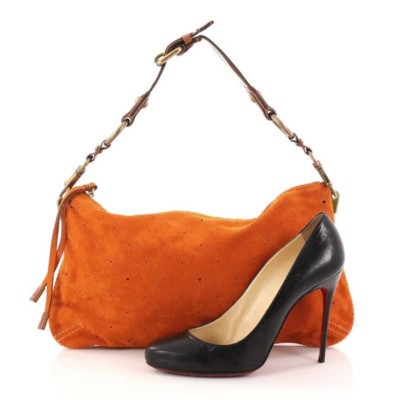This authentic Louis Vuitton Onatah Pochette Suede is a limited edition bag that is both stylish and functional. Crafted from orange monogram perforated suede, this bag from the Onatah collection features adjustable polyester striped handle with