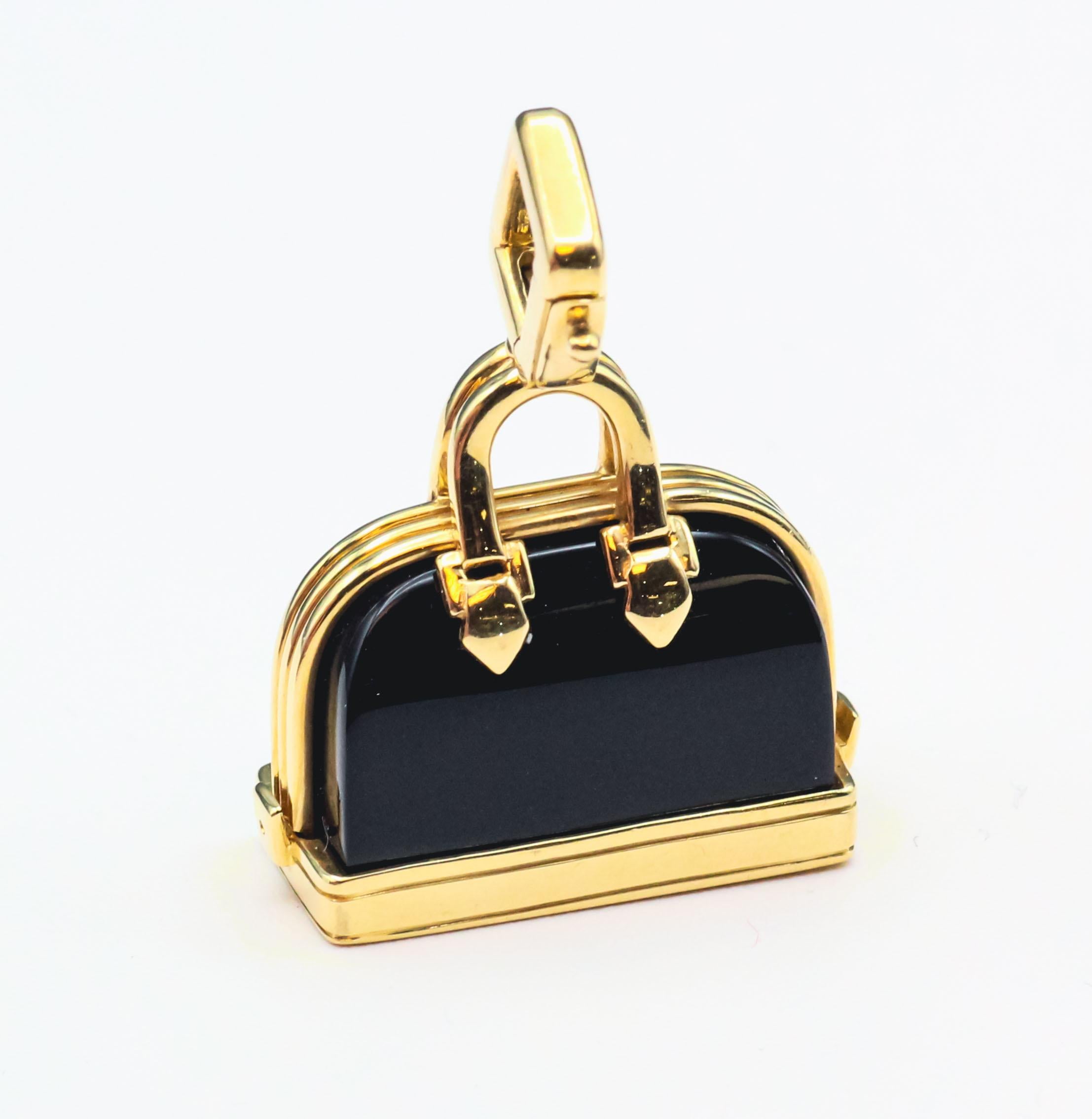 Elevate your style with this contemporary Louis Vuitton Onyx and 18k Yellow Gold Alma Bag Charm Pendant. This exquisite piece seamlessly combines modern luxury with the timeless elegance of Louis Vuitton, showcasing the brand's dedication to