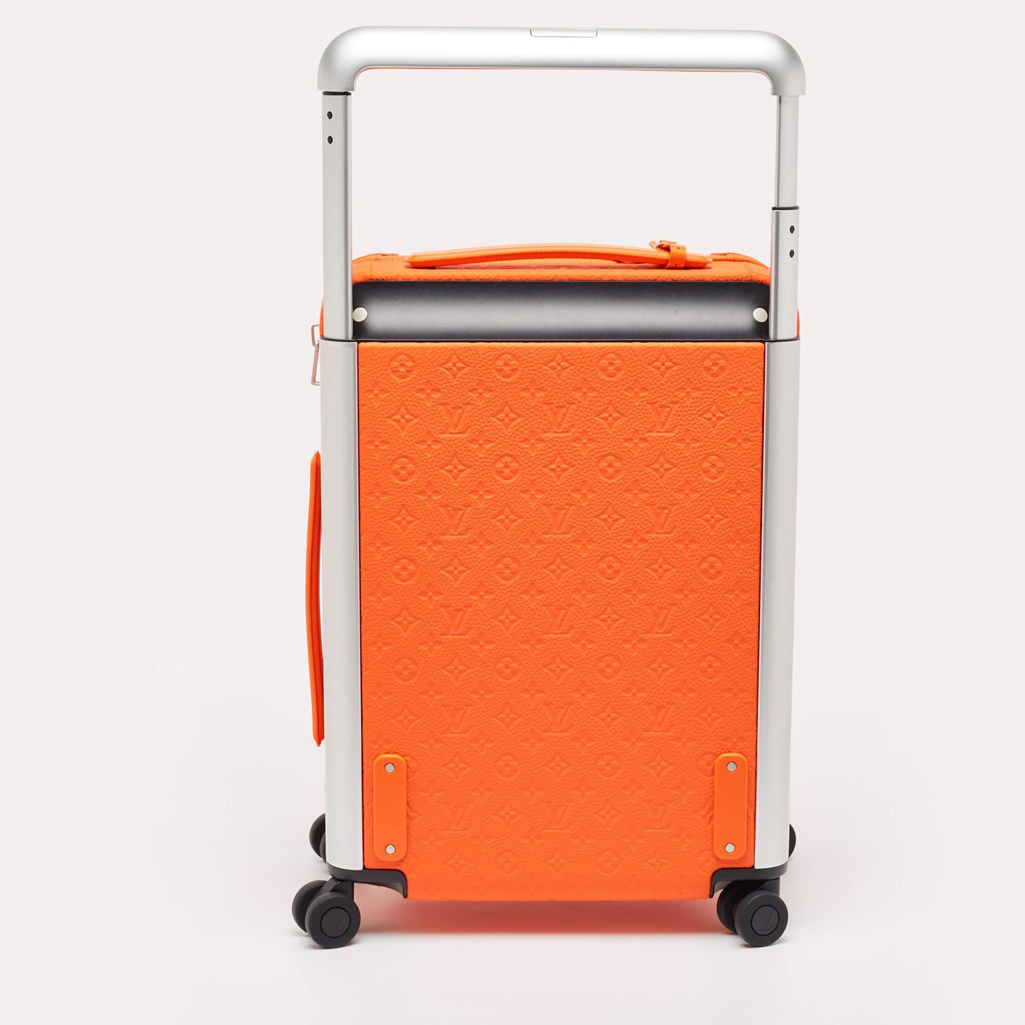 The Louis Vuitton Horizon 55 Suitcase is a luxurious travel accessory. Crafted from premium orange Empreinte leather, it features LV's iconic monogram pattern, a spacious interior, smooth wheels, and a telescopic handle, ensuring both style and