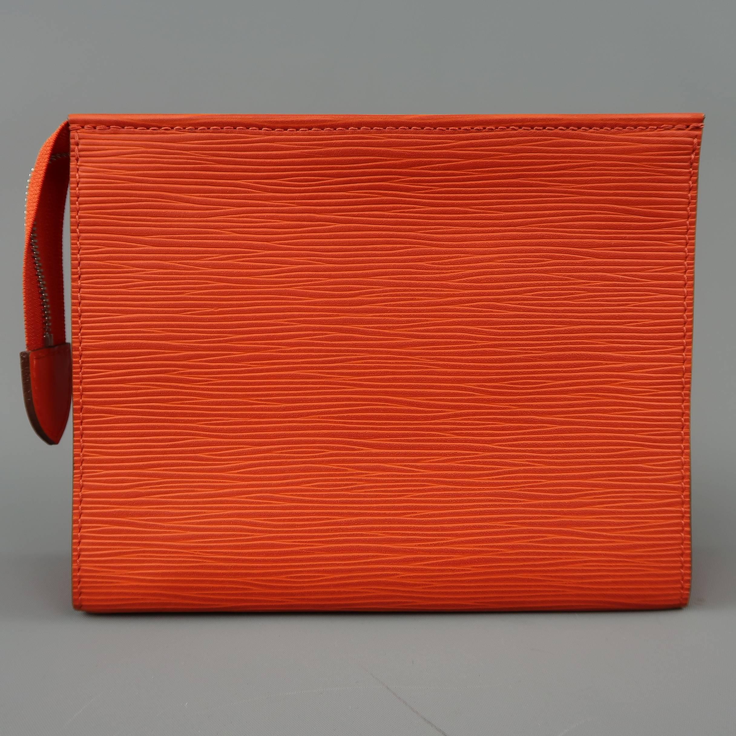 LOUIS VUITTON Toiletry Pouch 19 comes in orange Epi textured leather in a rectangular shape with a monogram embossed front and silver tone zip closure. Great as a small clutch as well. Made in France.
 
Excellent Pre-Owned Condition.
Marked: TA1174
