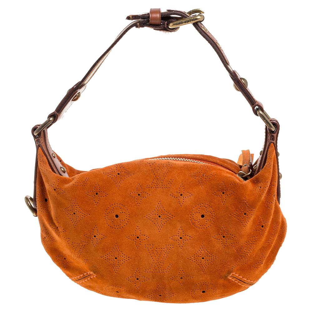 A limited-edition piece, this Onatah Fleurs bag by Louis Vuitton, is a marvelous bag with distinctive structure and unique details. Crafted with orange monogram suede, the bag's exterior is delicately perforated with LV monogram and is further