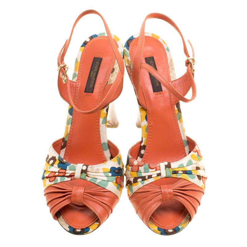 The house of Louis Vuitton brings forth this pair of lush ankle strap sandals that feature a summery floral print for a chic look. Crafted using a blend of leather and fabric these vibrantly orange sandals can bring about a stylish touch of elegance