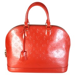 Louis Vuitton Alma GM Monogram Vernis en color naranja atardecer