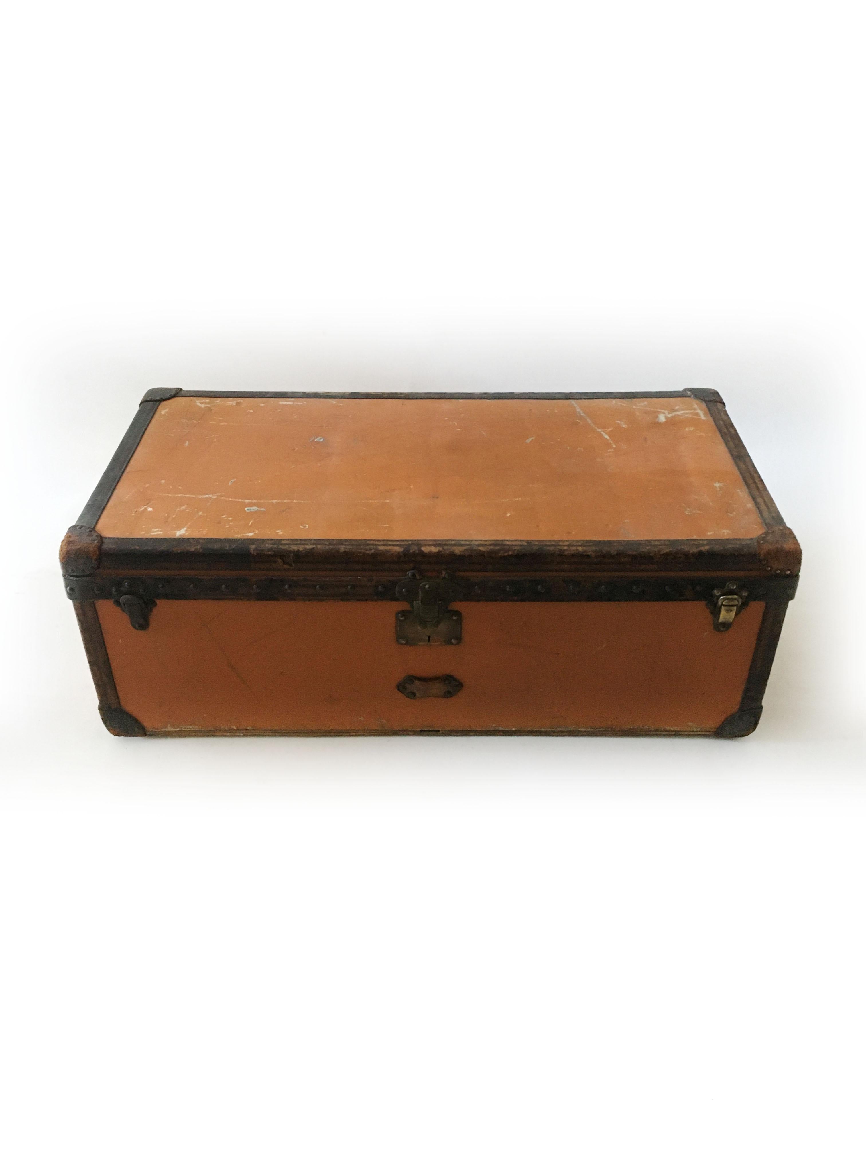 Large Louis Vuitton orange Vuittonite canvas steamer trunk, turn of the century, circa 1910. This wonderful Louis Vuitton orange Vuittonite trunk shows signs of wear, especially to the top that has been used for so many years. We didn't attempt to