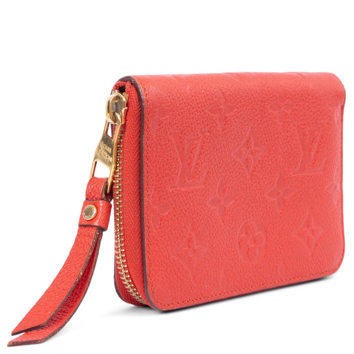 100% authentic Louis Vuitton Empreinte Secret Compact Wallet in Orient red grained calfskin featuring gold-tone hardware. Opens with a zipper on top and is lined in red calfskin with three credit card slots, a zipped coin-pocket and a large bill