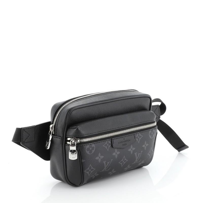 This Louis Vuitton Outdoor BumBag Monogram Taigarama, crafted from black monogram coated canvas and leather, features an adjustable strap, exterior front zip pocket and silver-tone hardware. Its top zip closure opens to a black fabric interior.