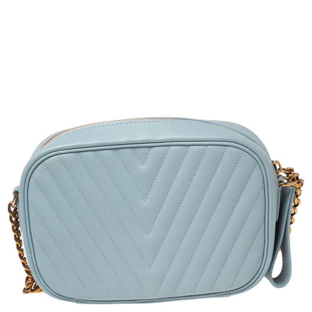 From the New Wave collection of bags by Louis Vuitton, this creation is crafted from pale blue leather and has a distinct wavy quilt pattern on the exterior. The bag has the LV logo on the front and an Alcantara interior secured by a branded zipper