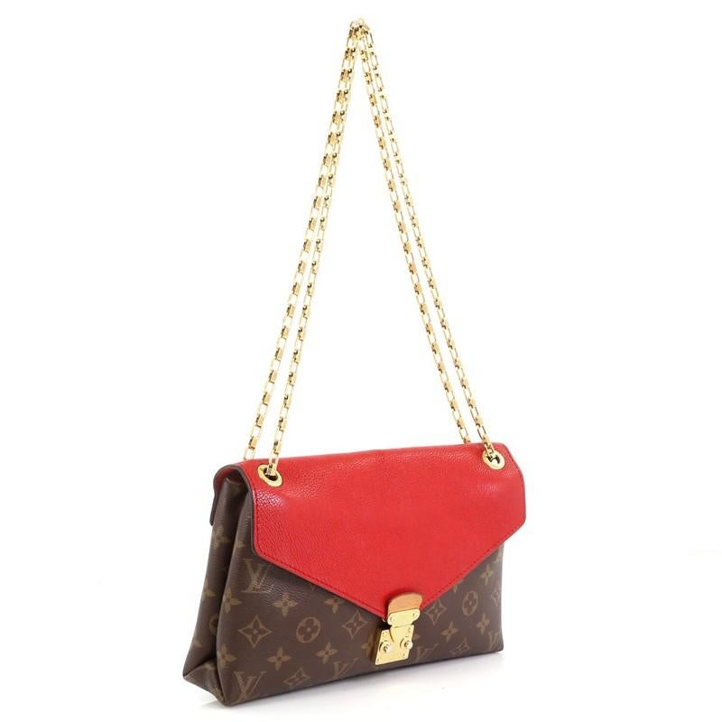 This Louis Vuitton Pallas Chain Shoulder Bag Monogram Canvas and Calf Leather, crafted from brown monogram coated canvas and red calf leather, features dual chain link strap and gold-tone hardware. Its S-lock closure opens to a red microfiber