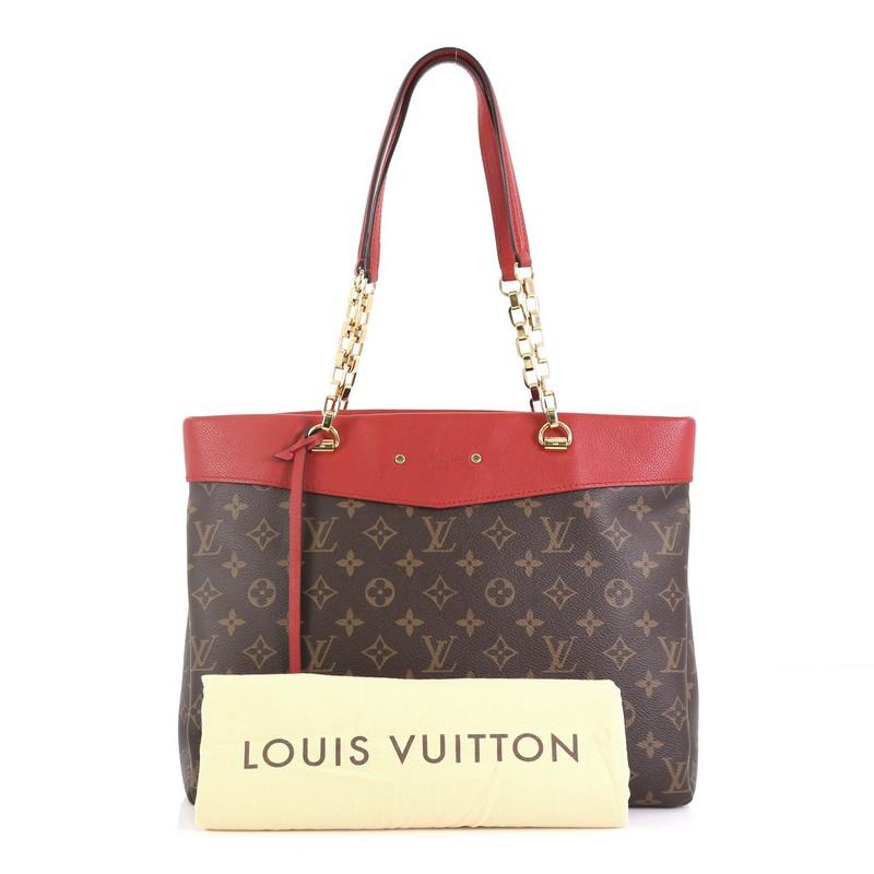 This Louis Vuitton Pallas Shopper Monogram Canvas and Calf Leather, crafted from brown monogram coated canvas with red calf leather trim, features chain handles with leather pads, protective base studs and gold-tone hardware. Its wide open top