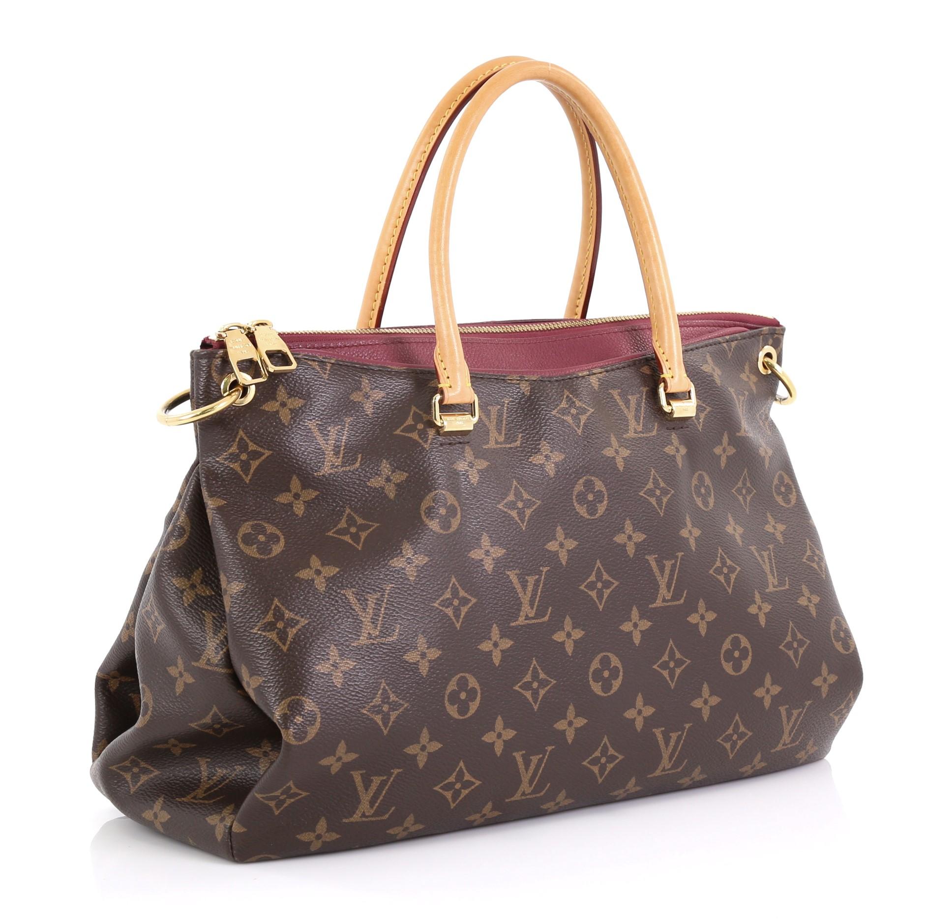 This Louis Vuitton Pallas Tote Monogram Canvas, crafted from brown monogram coated canvas and pink leather, features dual rolled handles, protective base studs, and gold-tone hardware. Its two-way zip closure opens to a burgundy microfiber interior
