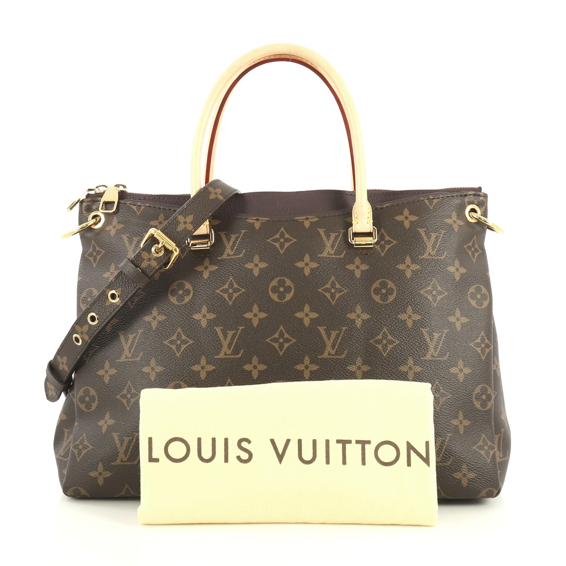 This Louis Vuitton Pallas Tote Monogram Canvas, crafted from brown monogram coated canvas, features dual rolled handles, protective base studs, and gold-tone hardware. Its two-way zip closure opens to a purple microfiber interior with slip pockets.