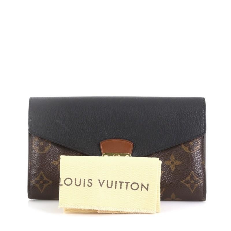 This Louis Vuitton Pallas Wallet Monogram Canvas and Calf Leather, crafted in brown monogram coated canvas and black calf leather, features gold-tone hardware. Its S-lock closure opens to a brown monogram coated canvas and black calf leather
