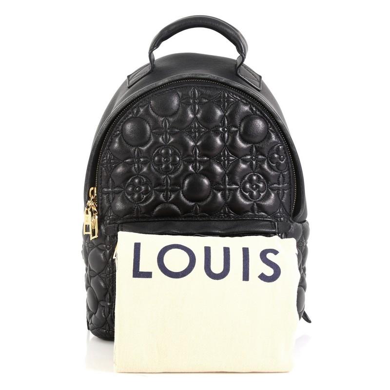 This Louis Vuitton Palm Springs Backpack Malletage Flower Lambskin PM, crafted from black malletage flower lambskin leather, features adjustable padded backpack shoulder straps, exterior front zip pocket, and gold-tone hardware. Its two-way zip