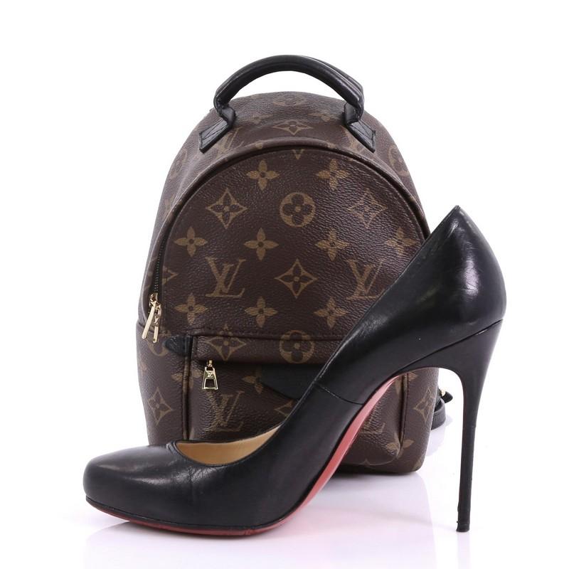 This Louis Vuitton Palm Springs Backpack Monogram Canvas Mini, crafted from brown monogram coated canvas, features a padded leather top handle, adjustable padded backpack shoulder straps, exterior front zip pocket, foam backing and gold-tone