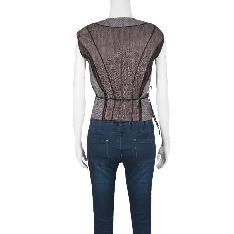 Wear it on its own or layer it with a top or camisole, this Louis Vuitton vest is perfect for both day time casual and even casual chic wear. Constructed in the hues of black and brown, this vest features a polka dotted wrap around front and python