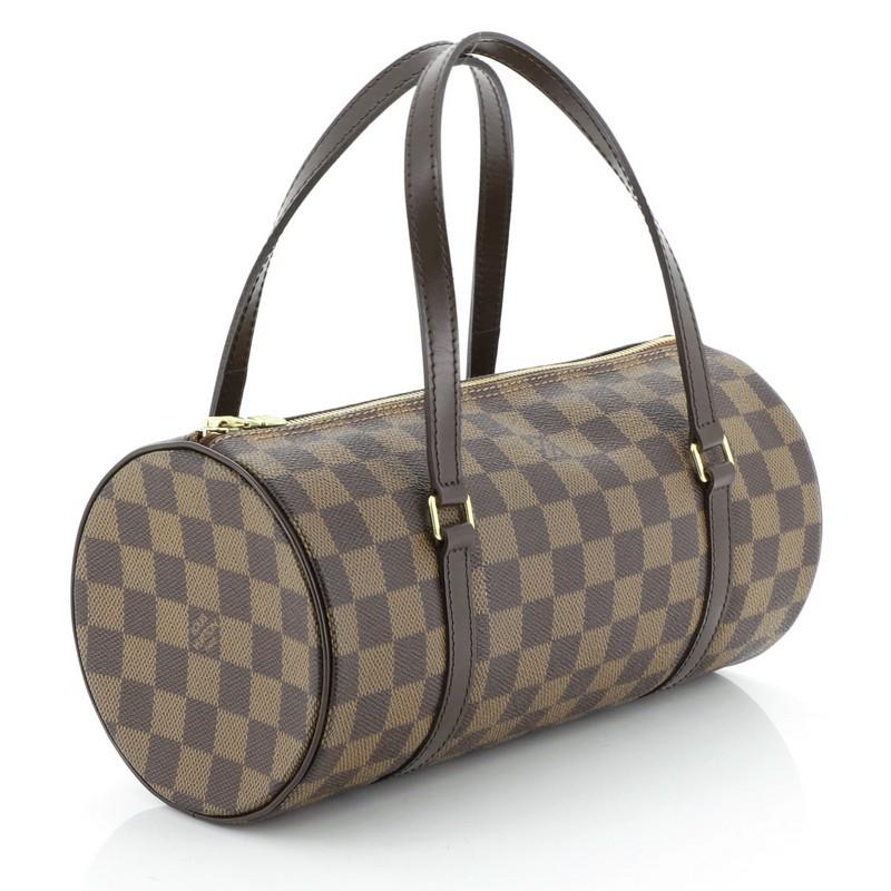 This Louis Vuitton Papillon Handbag Damier 26, crafted with damier ebene coated canvas, features dual leather handles, leather trim, and gold-tone hardware. Its zip closure opens to a red leather interior. Authenticity code reads: DU0067.