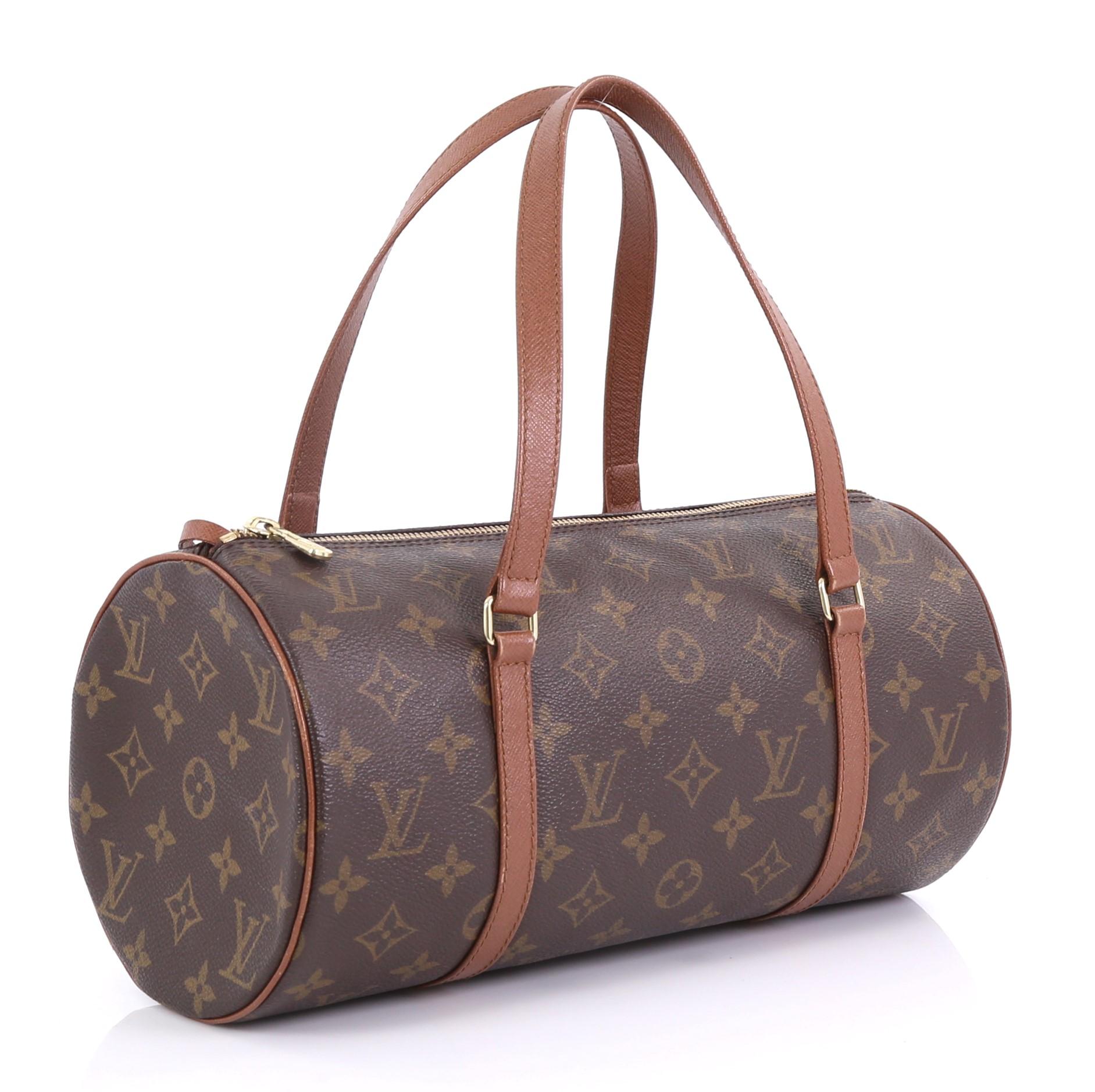 This Louis Vuitton Papillon Handbag Damier 30, crafted with damier ebene coated canvas, features dual leather handles, leather trim, and gold-tone hardware. Its zip closure opens to a brown leather interior. Authenticity code reads: NO0913.