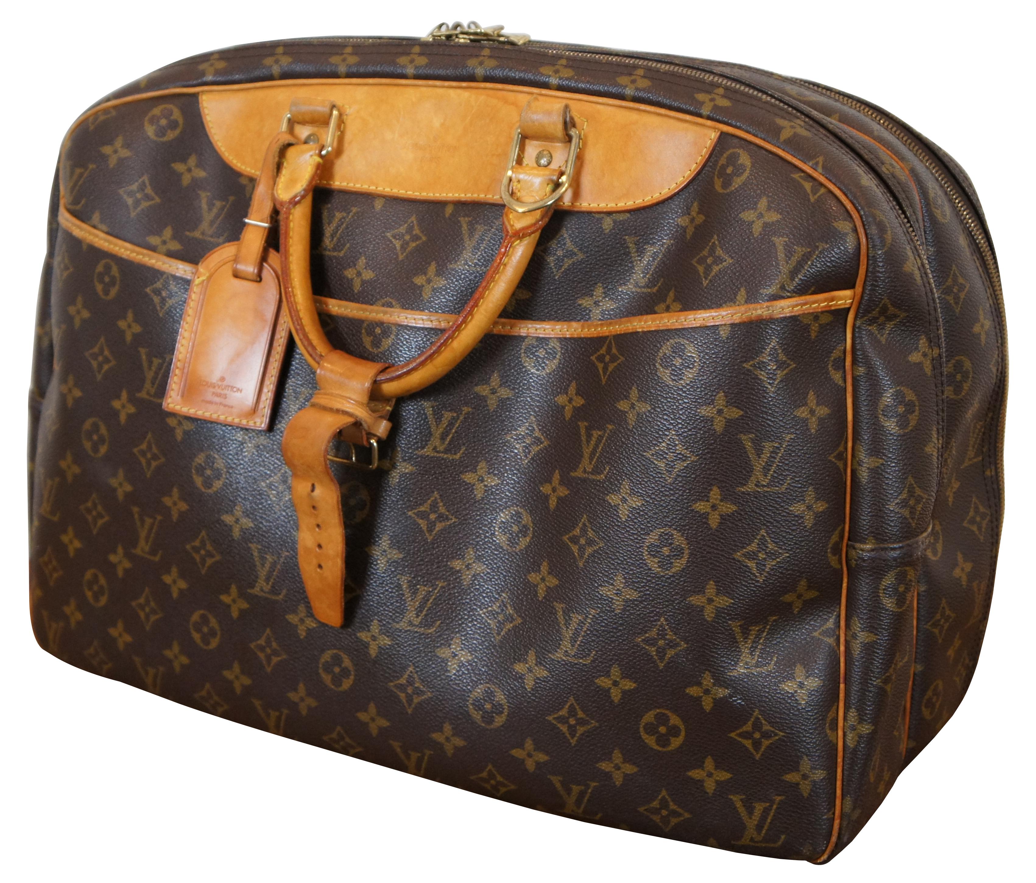 Louis Vuitton Paris Alize 24 Heures Monogram Travel Bag in the classic monogram pattern that features round top handles and gold-toned hardware. It is designed with a convenient front slip compartment. The bag opens up to 2 large compartments, both