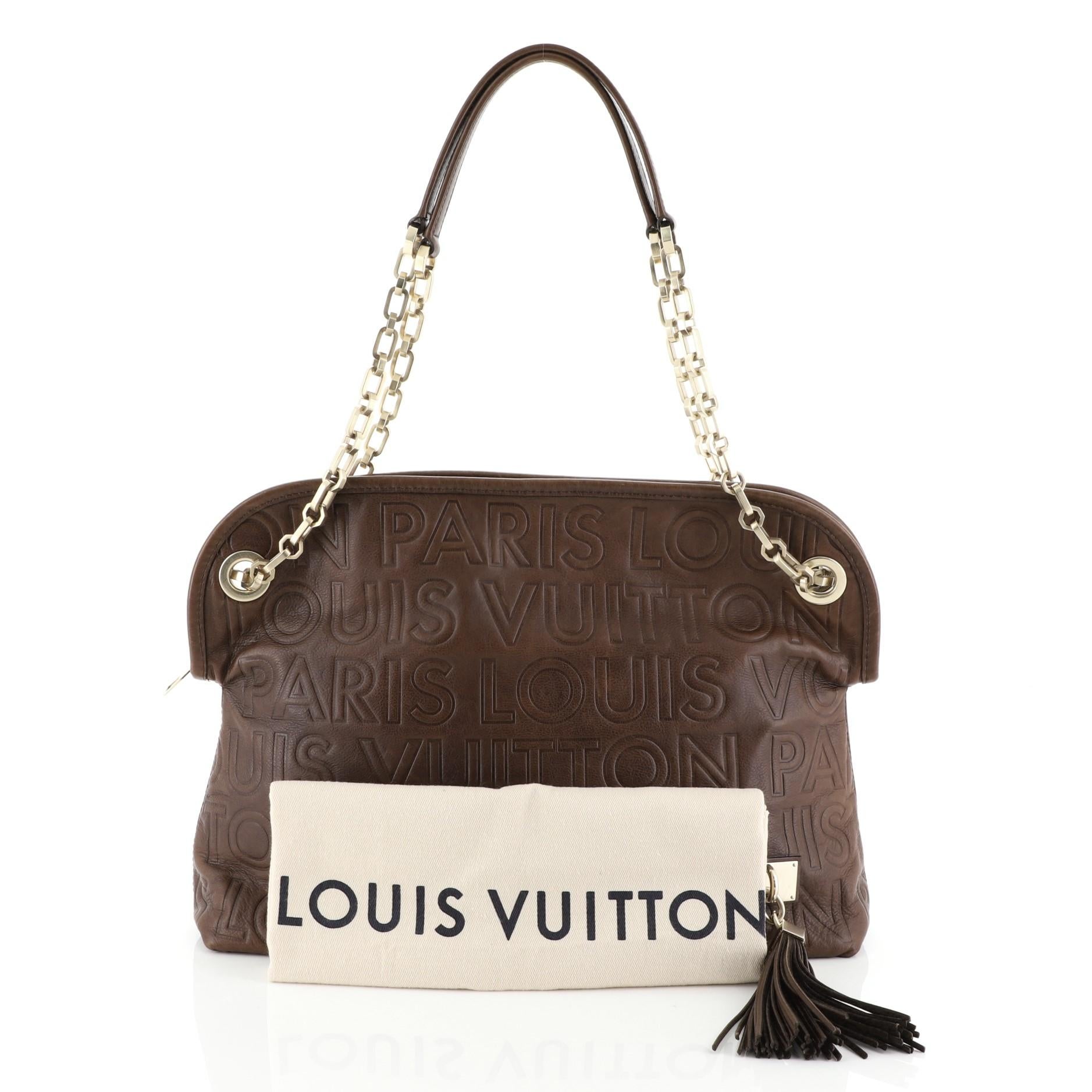 This Louis Vuitton Paris Souple Wish Bag Leather, crafted from brown leather, features dual leather handles with chain links, embossed Louis Vuitton logo throughout, leather tassel, and gold-tone hardware. Its zip closure opens to a brown microfiber
