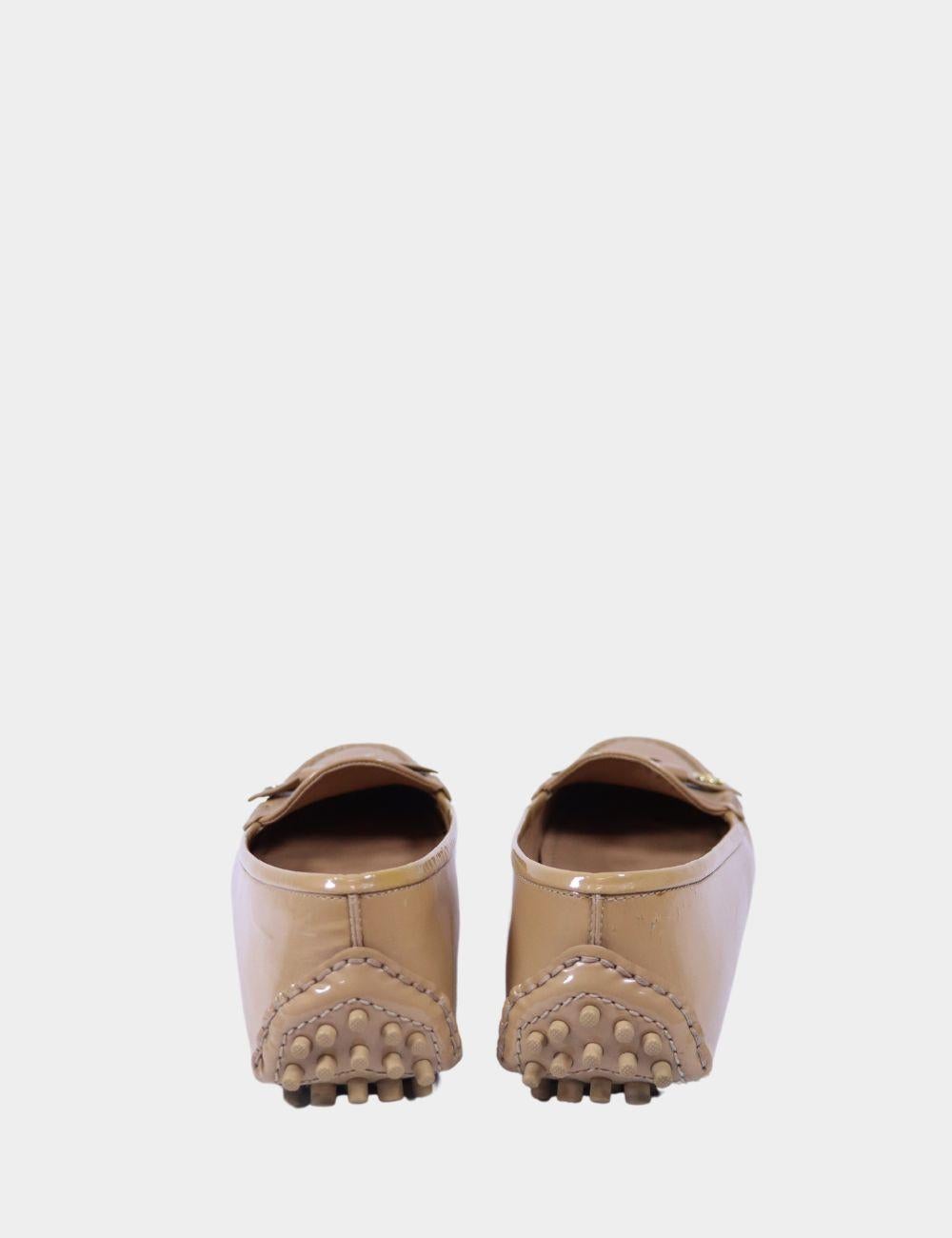 Step into refined elegance with these Louis Vuitton Nude Patent Leather Loafers, designed in a soft, neutral tone that complements every wardrobe. Made from glossy patent leather, these flats feature the brand's signature LV circle logo on a chic